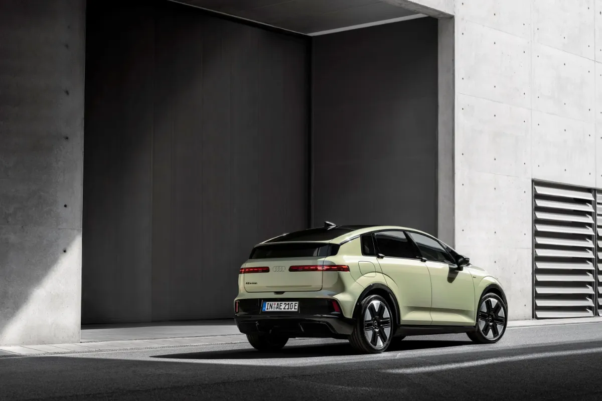 Ljusgrön Audi A2 e-tron snett bakifrån i en betonghall